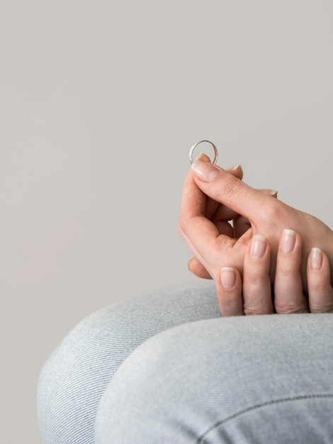 A woman holding a wedding ring